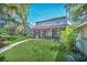 House back view, screened porch, and walkway at 21113 Kissimmee Shores Rd, Lake Wales, FL 33898