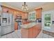 Kitchen boasts granite countertops, stainless steel appliances, and wood cabinets at 21113 Kissimmee Shores Rd, Lake Wales, FL 33898