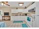 White kitchen features granite countertops and stainless steel appliances at 21113 Kissimmee Shores Rd, Lake Wales, FL 33898