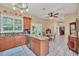 Open kitchen with granite island, stainless steel appliances, and breakfast nook at 21113 Kissimmee Shores Rd, Lake Wales, FL 33898