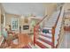 Living room with hardwood floors, fireplace, and staircase at 21113 Kissimmee Shores Rd, Lake Wales, FL 33898