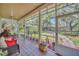 Serene screened porch overlooking backyard with lush landscape at 21113 Kissimmee Shores Rd, Lake Wales, FL 33898