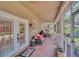 Spacious screened porch with wicker furniture and tiled floor at 21113 Kissimmee Shores Rd, Lake Wales, FL 33898