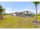 Large backyard with screened pool and spacious grassy area at 2330 Park Ave, Indian Lake Estates, FL 33855