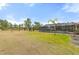 Spacious backyard with large grassy area and screened pool at 2330 Park Ave, Indian Lake Estates, FL 33855