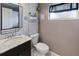 Small bathroom with granite countertop, toilet and updated decor at 2330 Park Ave, Indian Lake Estates, FL 33855