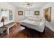 Spacious bedroom with hardwood floors and a comfortable adjustable bed at 2330 Park Ave, Indian Lake Estates, FL 33855