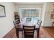 Dining area with wooden table and chairs, view of pool at 2330 Park Ave, Indian Lake Estates, FL 33855