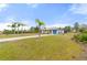 Single-story home with palm trees and a long driveway at 2330 Park Ave, Indian Lake Estates, FL 33855