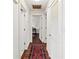 Bright hallway with hardwood floors and a patterned rug leading to other rooms at 2330 Park Ave, Indian Lake Estates, FL 33855