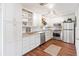 Modern kitchen with white cabinets and stainless steel appliances at 2330 Park Ave, Indian Lake Estates, FL 33855