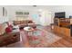 Living room with L-shaped sectional sofa and hardwood floors at 2330 Park Ave, Indian Lake Estates, FL 33855