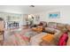 Spacious living room with L-shaped sectional sofa and large area rug at 2330 Park Ave, Indian Lake Estates, FL 33855