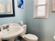 Small bathroom with pedestal sink and updated fixtures at 2400 Crump Rd, Winter Haven, FL 33881