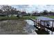 Private dock with covered boat shelter on a tranquil lake at 2400 Crump Rd, Winter Haven, FL 33881