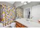 Bathroom with bathtub, toilet, and patterned shower curtain at 2739 Rutledge Ct, Winter Haven, FL 33884