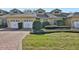 Tan two-story home with two-car garage and landscaped yard at 2739 Rutledge Ct, Winter Haven, FL 33884