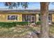 Rear exterior view showcasing a screened patio and well-manicured landscaping at 2739 Rutledge Ct, Winter Haven, FL 33884