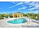 Community pool with ample lounge chairs and a covered seating area at 2739 Rutledge Ct, Winter Haven, FL 33884