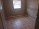 Simple bedroom with tile floors and a window at 2790 Avenue L Nw, Winter Haven, FL 33881