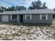 Newly painted gray brick ranch home with a spacious yard and attached garage at 2790 Avenue L Nw, Winter Haven, FL 33881