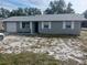 Newly painted gray brick ranch home with a spacious yard and attached garage at 2790 Avenue L Nw, Winter Haven, FL 33881