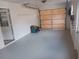 Garage with painted floor and overhead door at 2790 Avenue L Nw, Winter Haven, FL 33881