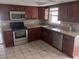 Modern kitchen with stainless steel appliances and ample wood cabinets at 2790 Avenue L Nw, Winter Haven, FL 33881