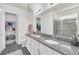 Double vanity bathroom with granite countertop and a walk-in shower at 2821 Mead Ave, St Cloud, FL 34771