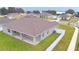Aerial view of home showcasing the backyard, covered patio, and surrounding landscape at 304 Denna Ln, Auburndale, FL 33823