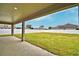 View of the fenced backyard and covered patio perfect for outdoor entertaining and relaxation at 304 Denna Ln, Auburndale, FL 33823