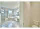 Large bathroom with double vanity, bathtub, walk-in shower, and marble-look tile at 304 Denna Ln, Auburndale, FL 33823