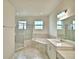Bathroom with soaking tub and double vanity at 304 Denna Ln, Auburndale, FL 33823
