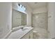 Bright bathroom features a granite countertop, tile flooring and a bathtub and shower combo at 304 Denna Ln, Auburndale, FL 33823