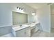 Elegant bathroom featuring a double vanity and marble countertops at 304 Denna Ln, Auburndale, FL 33823