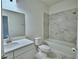 Bathroom featuring a white sink, toilet, and marble look tile in the shower at 304 Denna Ln, Auburndale, FL 33823