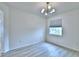 Comfortable bedroom featuring wood floors, modern lighting, and a window with blinds at 304 Denna Ln, Auburndale, FL 33823