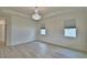 Bedroom with hardwood floors, neutral walls, and a modern chandelier at 304 Denna Ln, Auburndale, FL 33823
