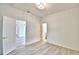 This bedroom features new laminate flooring and white walls at 304 Denna Ln, Auburndale, FL 33823