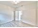 Bedroom showcases new laminate flooring, overhead lighting, and neutral paint at 304 Denna Ln, Auburndale, FL 33823