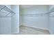 Spacious walk-in closet with metal shelving and light wood-look floors at 304 Denna Ln, Auburndale, FL 33823