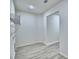 Spacious walk-in closet with white walls, light wood-look floors, and metal shelving at 304 Denna Ln, Auburndale, FL 33823