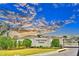 Lake Ariana Estates entrance with lush landscaping, providing a welcoming and secure community at 304 Denna Ln, Auburndale, FL 33823
