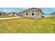Exterior angle of home highlighting stone accents and manicured lawn at 304 Denna Ln, Auburndale, FL 33823
