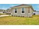 View of home featuring stone veneer accents and a well maintained lawn at 304 Denna Ln, Auburndale, FL 33823