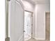 Hallway featuring white trim, modern doors, and easy access to other rooms at 304 Denna Ln, Auburndale, FL 33823