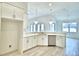 Clean kitchen featuring white cabinets, countertops, and stainless steel appliances at 304 Denna Ln, Auburndale, FL 33823