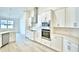 Updated kitchen features white cabinets, stainless appliances, and modern lighting at 304 Denna Ln, Auburndale, FL 33823