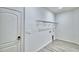 A laundry room featuring built-in wire shelving for easy storage and vinyl flooring at 304 Denna Ln, Auburndale, FL 33823