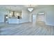 Open living area with hardwood floors, high ceilings and stylish light fixtures at 304 Denna Ln, Auburndale, FL 33823